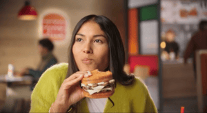 Woman enjoys new Burger King melt in ad for Burger King.