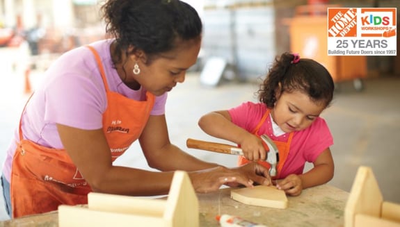 A woman and a girl do a home improvement project as part of Home Depot's children's workshops.